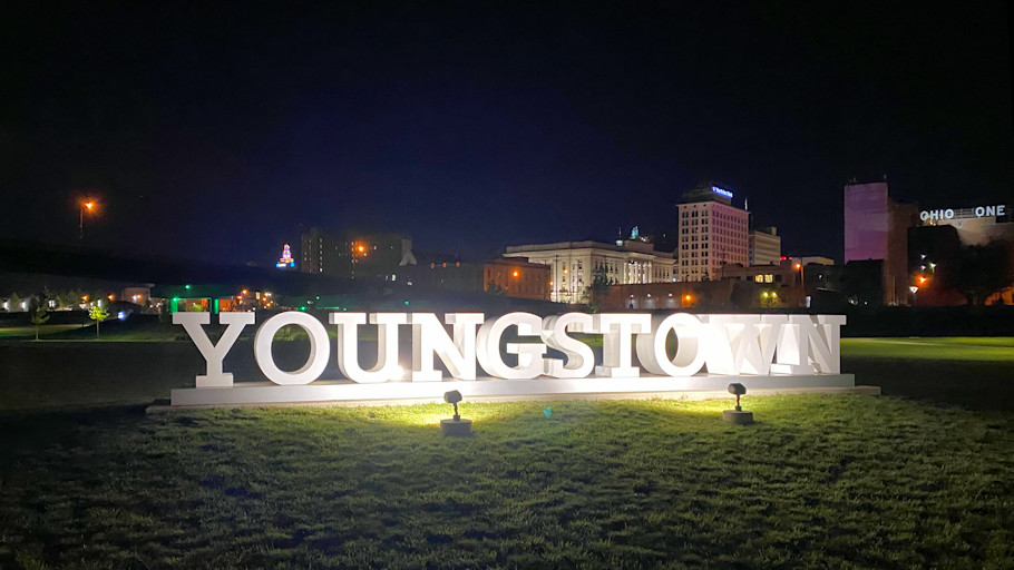 Downtown Youngstown skyline in background, as seen from Wean Park; YOUNGSTOWN logotype sculpture in foreground.