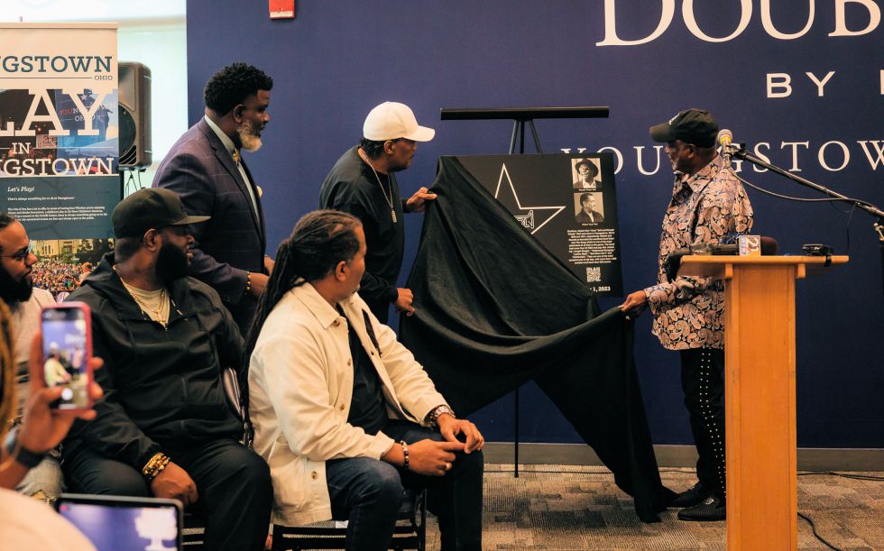 Pulling the cover off the plaque of Kool & The Gang at the induction ceremony. Photo Credit: Stephanie Sheronovich
