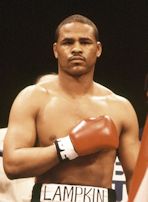 Photo of Jeff Lampkin in the ring, prior to a fight, with his gloved right arm over his chest.